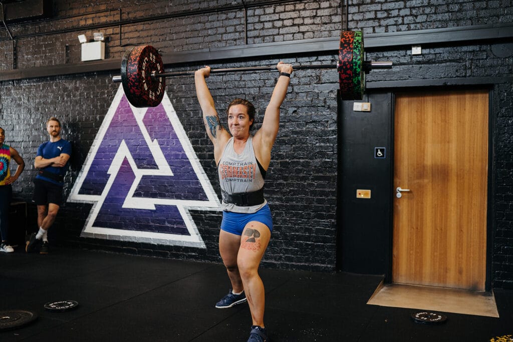 CrossFit Coach Angela completing and Clean and Jerk movement. 